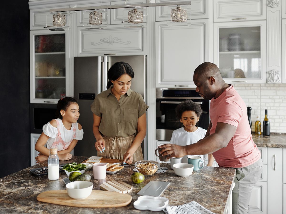 Family preparing food together in a bright kitchen