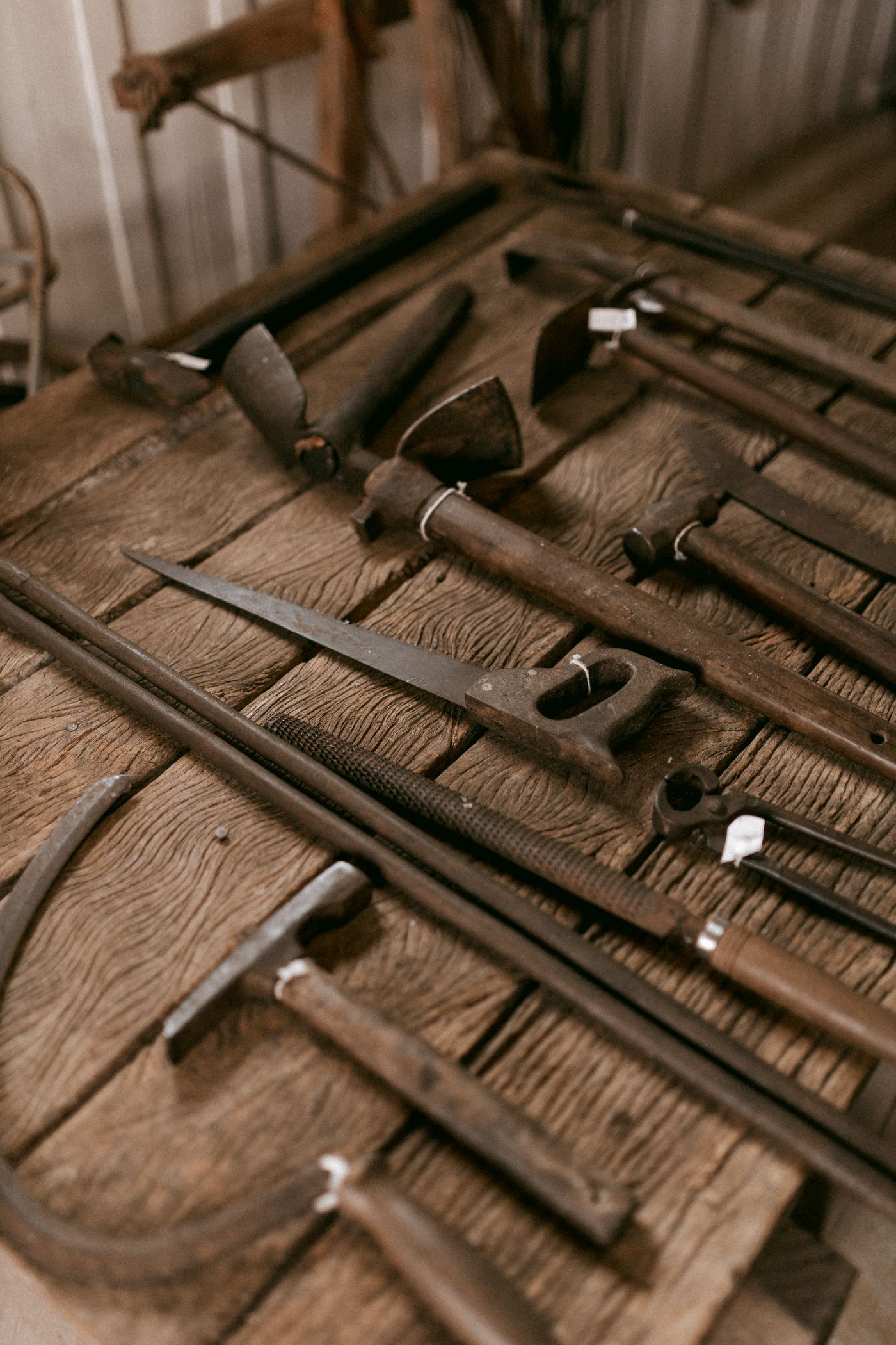 Hand tools arranged on a wooden workbench